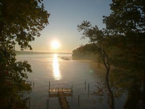 2b6d61f5069db34d0ba8227c8f305fed-285×214 a sunset over a body of water