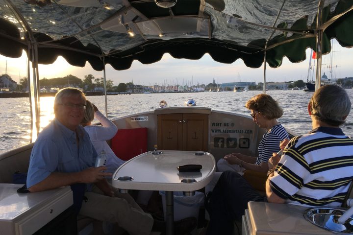 a group of people sitting at a table with an umbrella