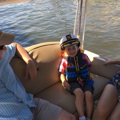 a person sitting on a boat in a body of water