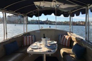 a close up of an umbrella on a dock near the water