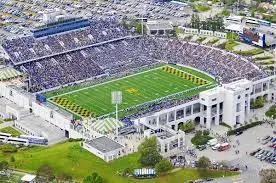 a stadium with a building in the background
