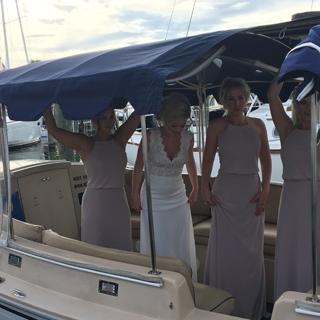 a group of people standing in front of a boat