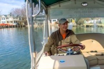a man sitting on a boat in the water